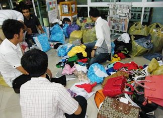 Copyright police sort through piles of counterfeit garments.